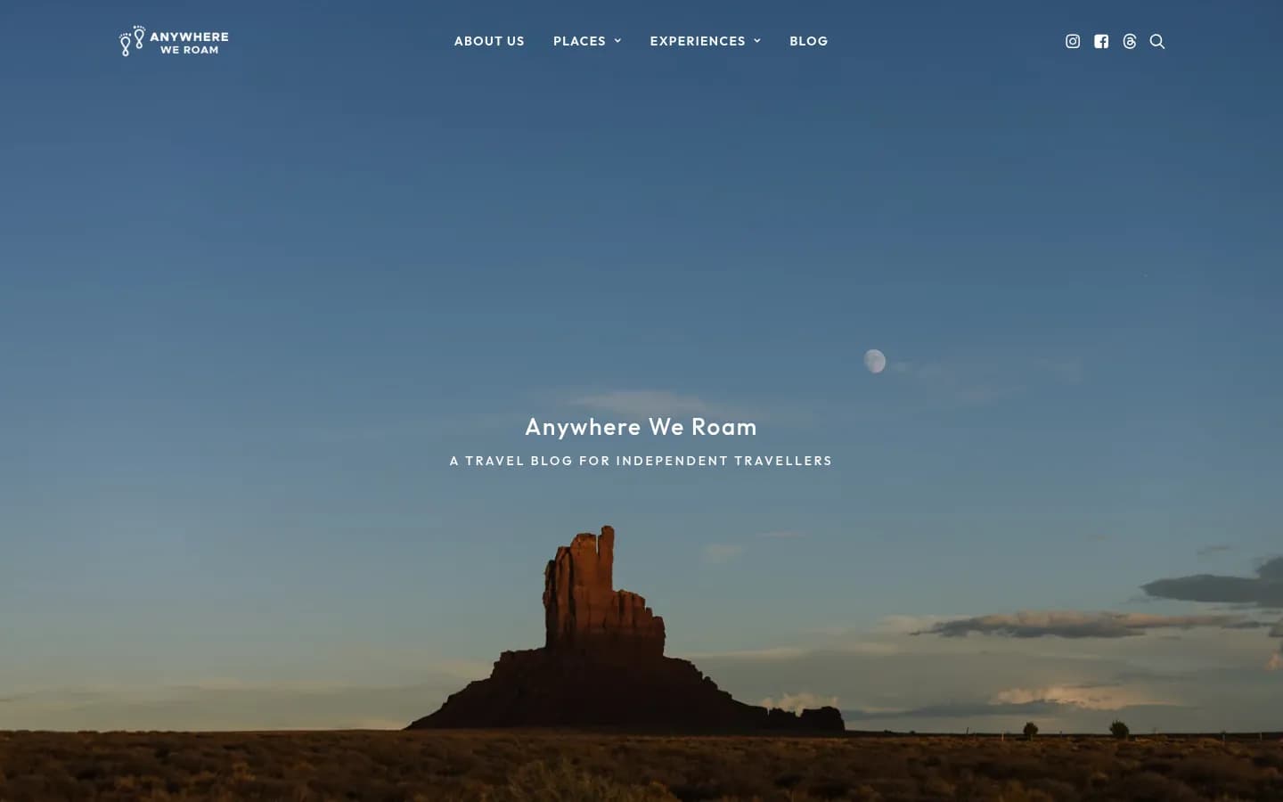 Anywhere We Roam travel blog home page with a desert butte at sunset