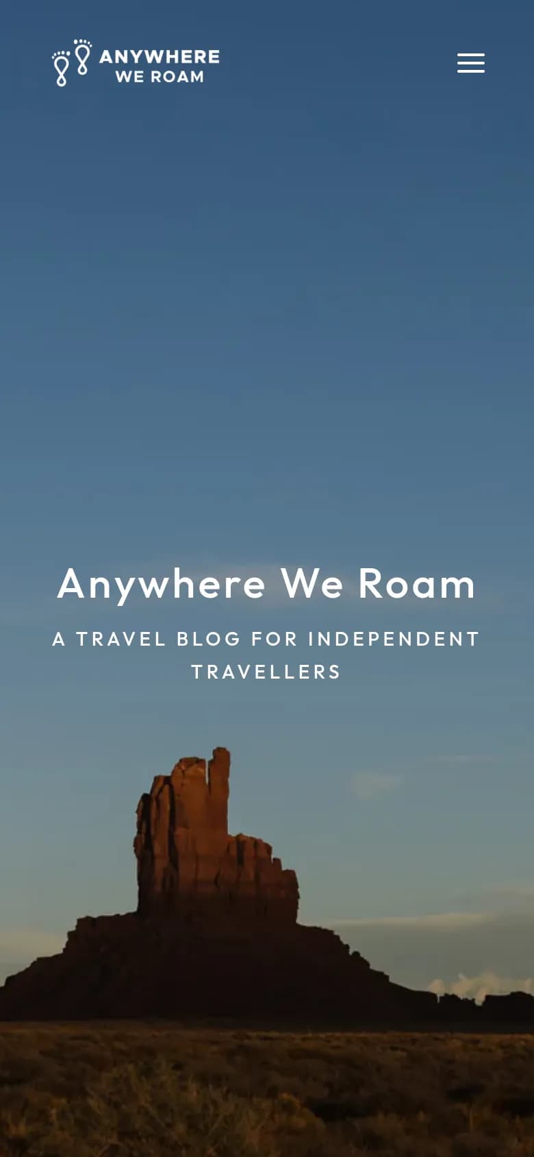 Anywhere We Roam travel blog on a phone with a desert butte at sunset
