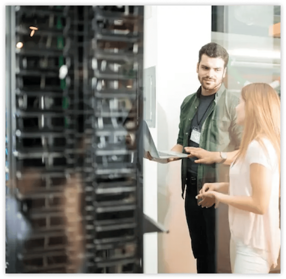 a close-up of a server 2 workers do technical check