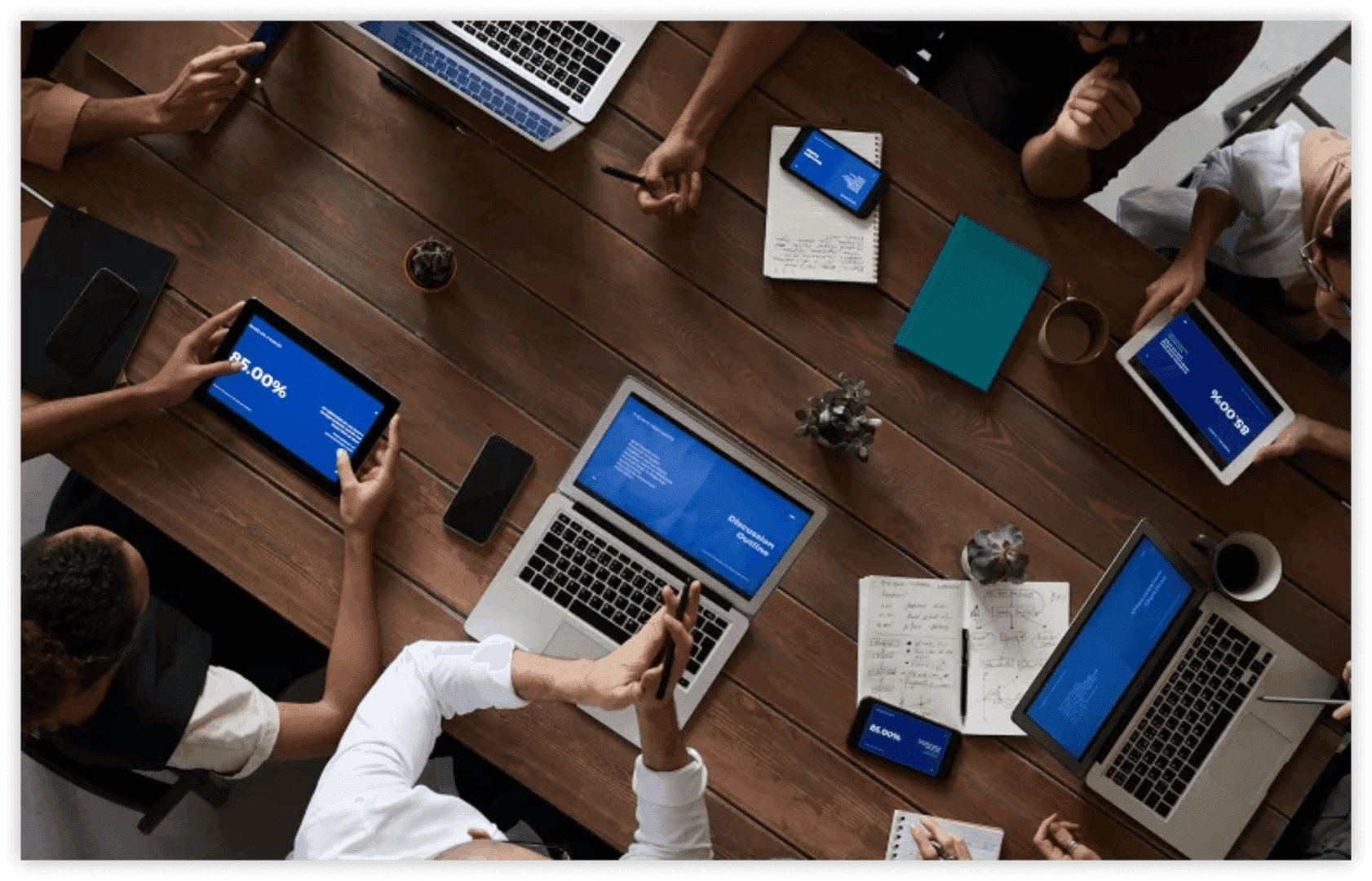 group of people sitting on a chair with laptop on a table