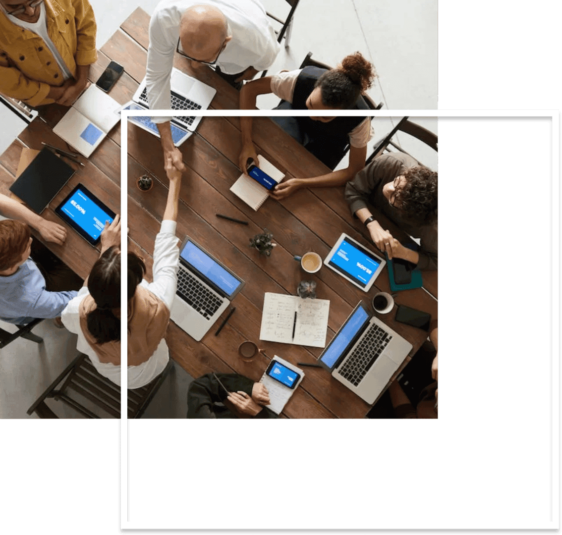 a group of people around a table discussing about new web design project